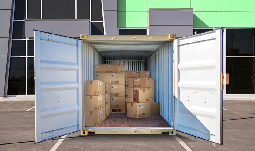 shipping-container-with-open-doors-and-boxes-inside-in-parking-lot